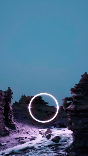 Surreal landscape with glowing ring and rock formations