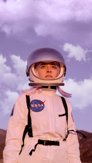 Girl in NASA astronaut cosplay with purple hair