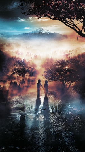 Two children holding hands in front of a misty mountain landscape