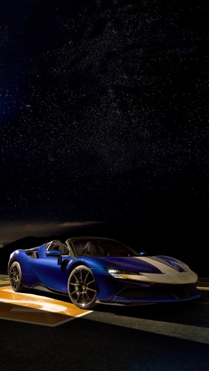 Blue Ferrari SF90 Spider convertible under starry night sky
