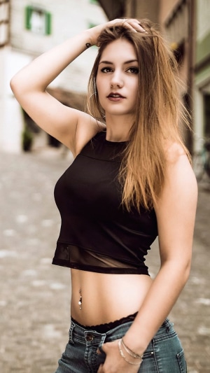 Woman in black crop top and jeans