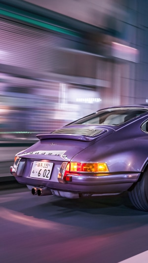 Purple Porsche 911 driving at night