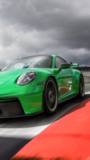 Green Porsche 911 GT3 R on a race track