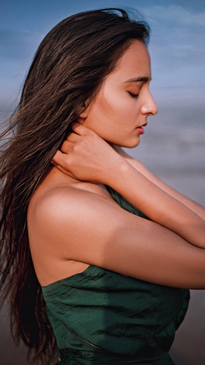 Model with dark hair by the sea