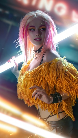 Girl with pink hair and yellow fringe top holding a light tube