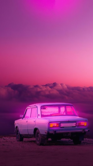 Vintage car on a pink and purple sunset sky