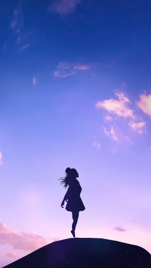 Silhouette of a girl on a hill at dusk