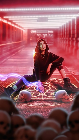 Woman in hoodie sitting on occult circle with skulls