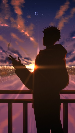 Silhouette of a person smoking on a balcony at sunset
