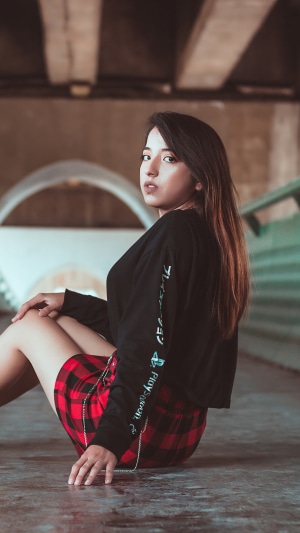 Girl in black shirt and plaid skirt