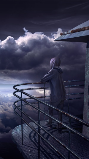 Person in hoodie on observation deck overlooking clouds
