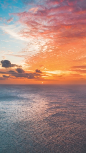Sunset over the ocean with colorful clouds