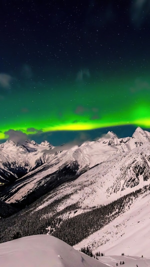 Aurora Borealis over snow-covered mountains