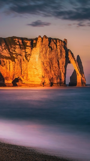 Etretat cliffs at sunset over the ocean