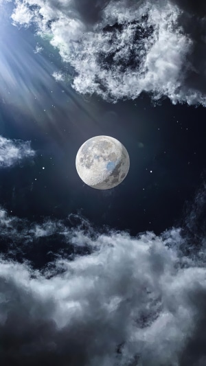 Full moon in a cloudy night sky
