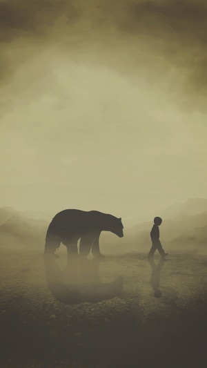 Bear and child walking in a misty landscape