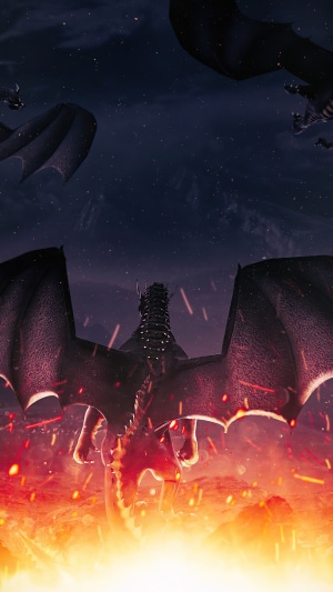 Dragons flying over a fiery landscape at night