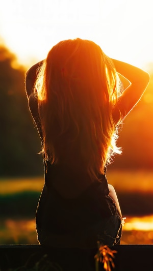 Girl silhouetted against sunset