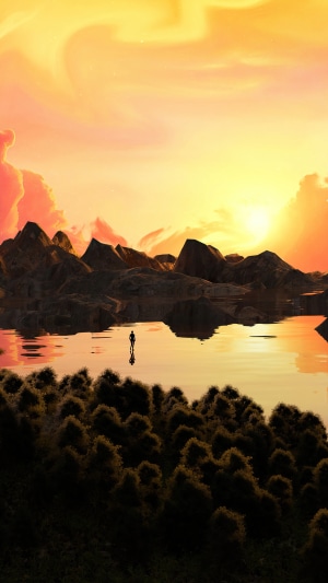 A lone figure stands in a lake at sunset