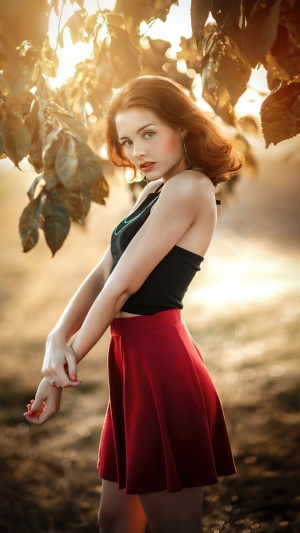 Woman in black top and red skirt