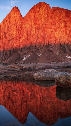 Mountain reflection in a calm lake at sunrise