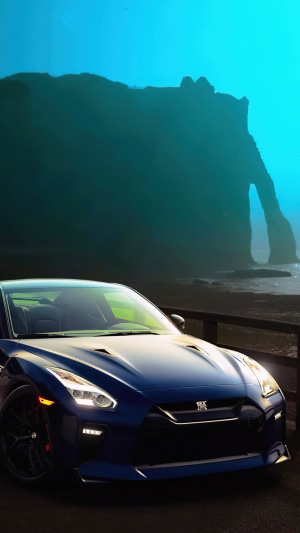 Blue Nissan GT-R on a rocky coast