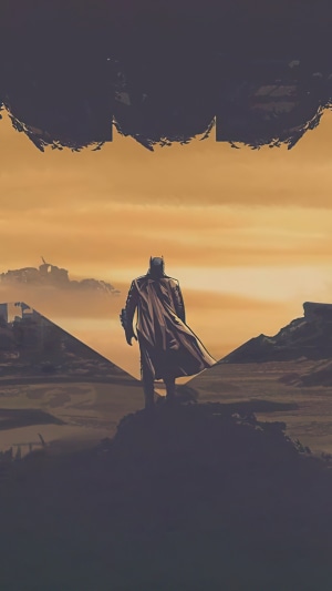 Batman standing on a rock overlooking a desolate landscape