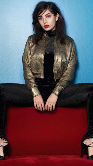 Charli XCX in a gold jacket