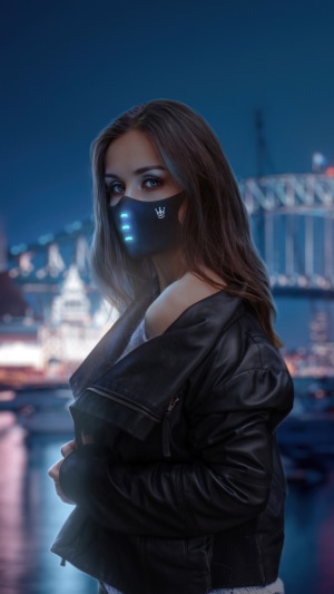 Woman wearing a futuristic mask at night