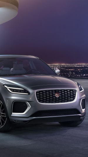 Jaguar E-Pace SUV at night with city lights