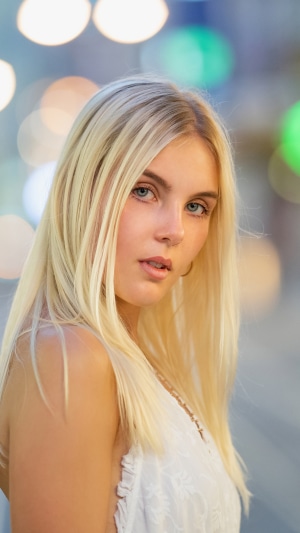Blonde girl with blue eyes in white dress