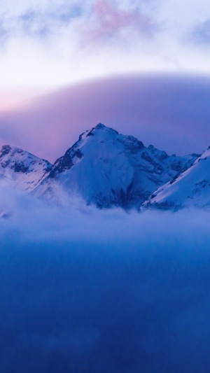 Snow-capped mountains shrouded in mist
