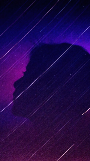 Silhouette of a person against a starry night sky