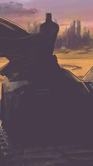 Batman on a vehicle in a desolate landscape