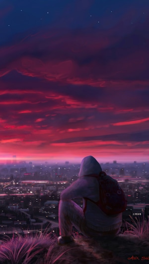 Person in hoodie overlooking city at sunset