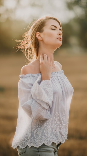 Woman with eyes closed in a field