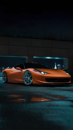 Orange Ferrari 458 Italia parked at night