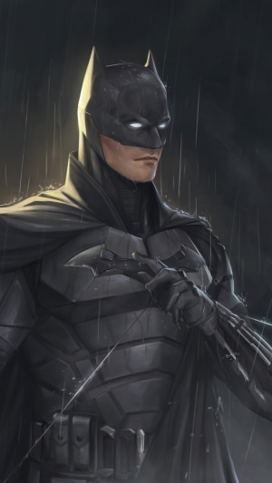 The Batman holding a Batarang in the rain