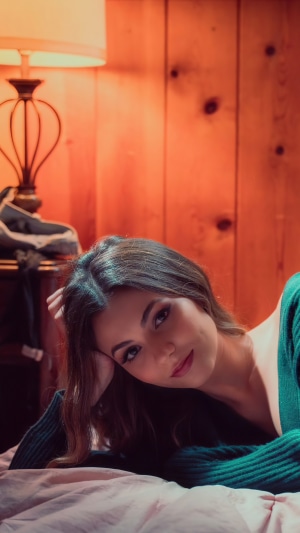 Victoria Justice relaxing on a bed