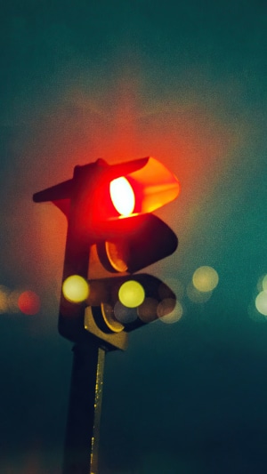 Red traffic light at night with bokeh