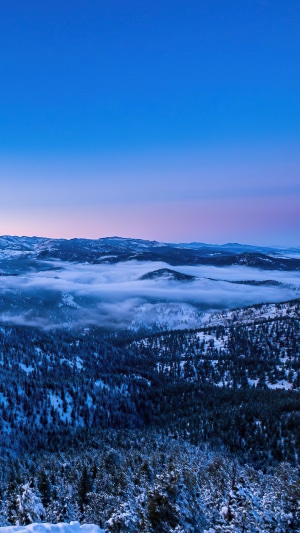 Mountains covered in snow and fog at sunrise 4K