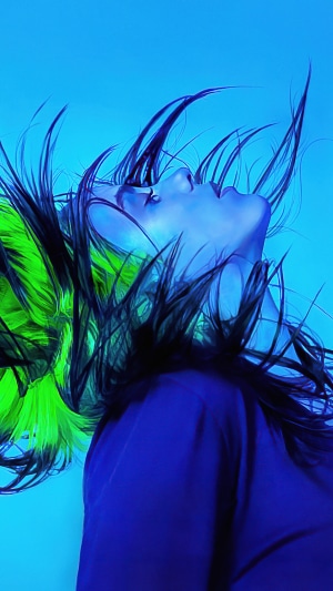 Billie Eilish with green and blue lighting