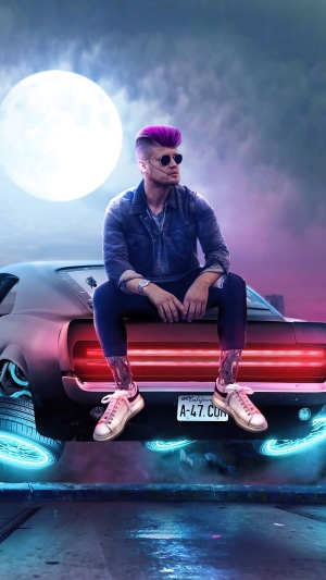 Man with purple hair sitting on a car