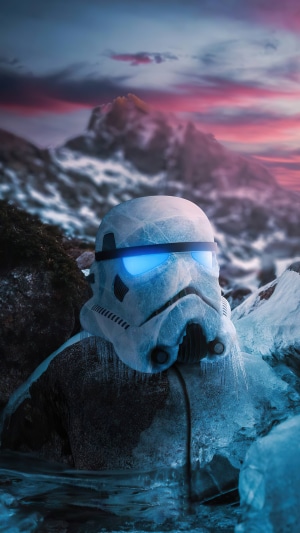Stormtrooper helmet covered in ice in a snowy mountain landscape