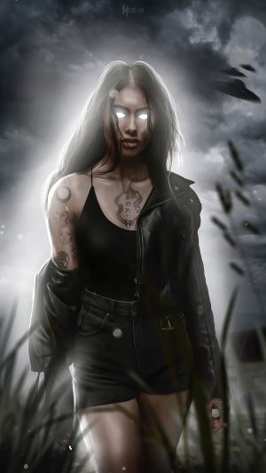 Woman with glowing eyes and tattoos