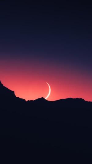 Crescent moon over mountains at sunset 4K
