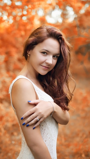 Girl in white dress in autumn forest