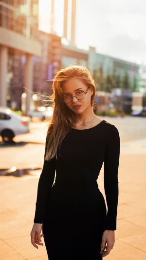 Girl in black dress wearing glasses