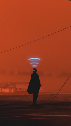 Silhouette of a person with glowing eyes and rings above their head