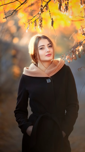 Girl in autumn park wearing a coat